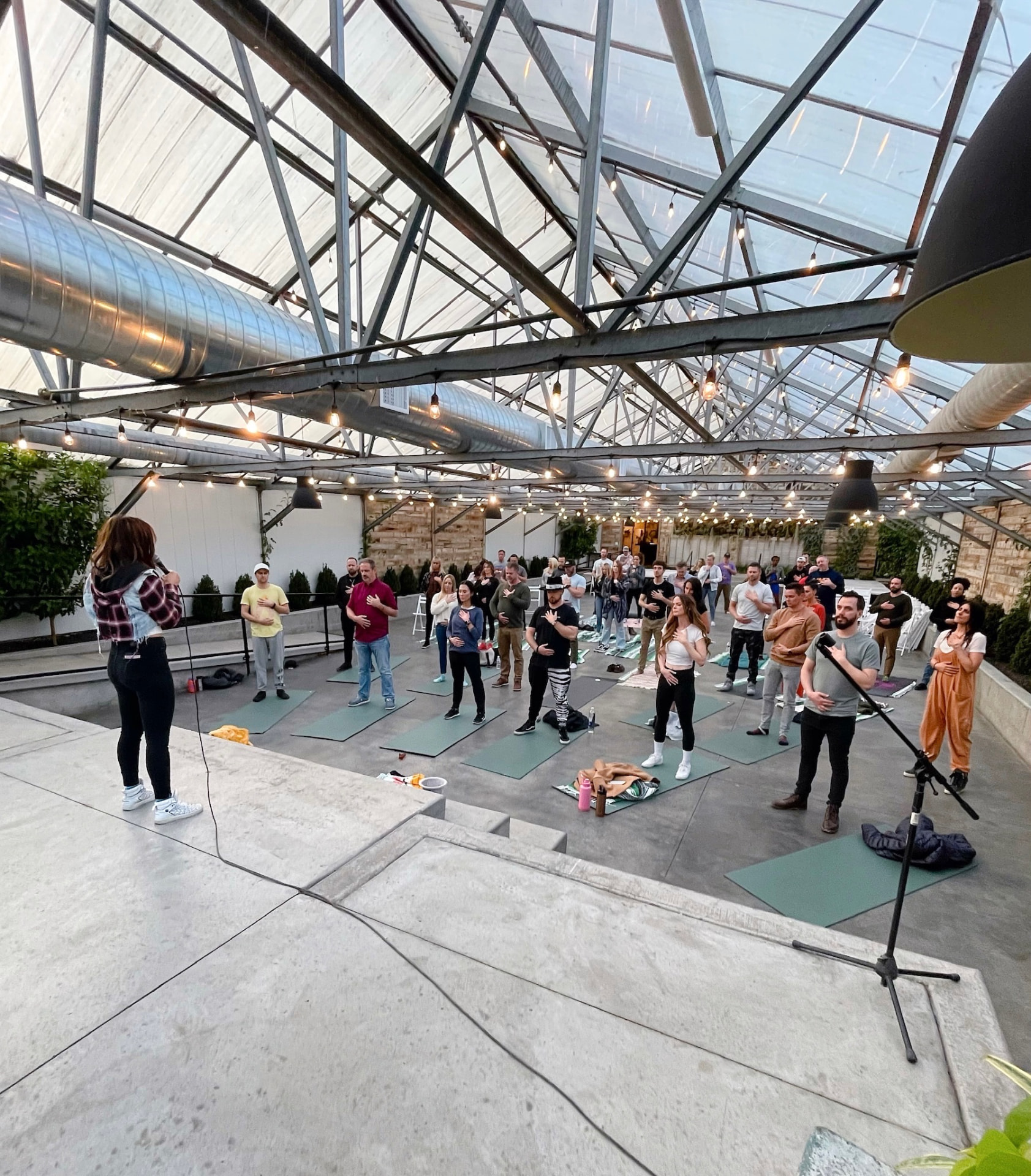 Rachele leading a live Hero Within style community session in a greenhouse